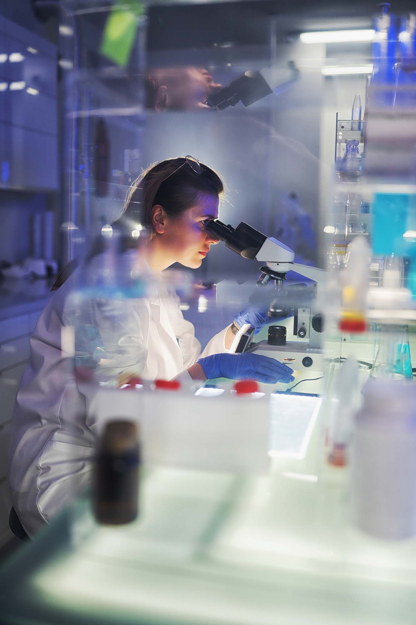 Woman using microscope